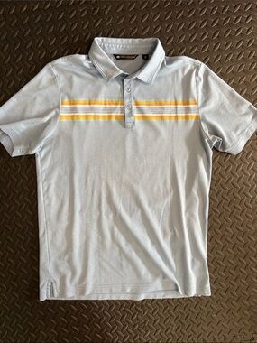 Travis Mathew Pale Blue Polo with Yellow and Orange Chest Stripes